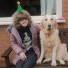 Chloe and Sapphire sit together outside on a wooden bench.