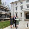 Three people standing outside Winslade House and Winslade Manor