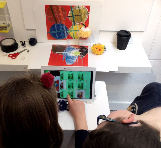 Kids filming hand made pom poms at Devon Guild