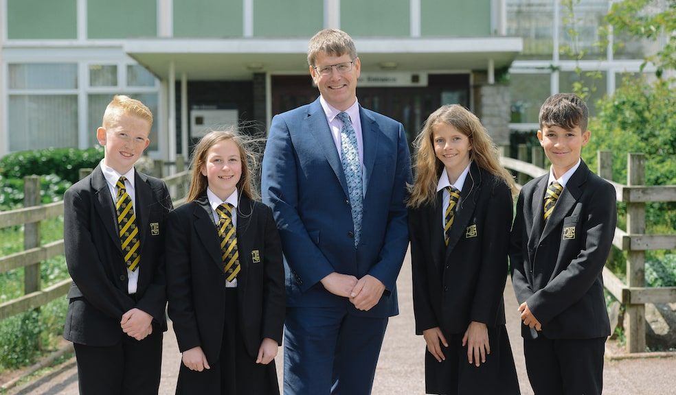 Headteacher Rupert Poole with students from Queen Elizabeth's School