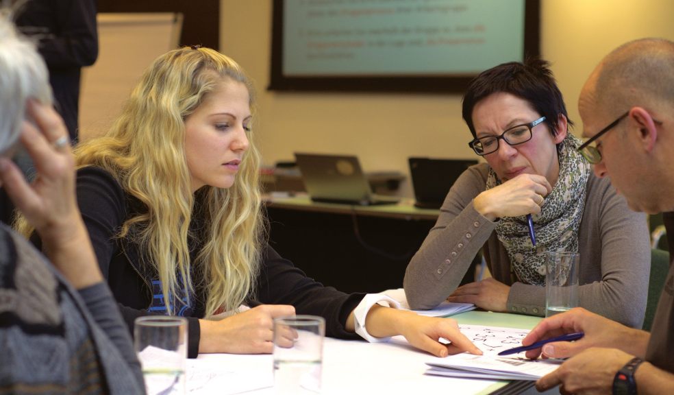 people sat around a table at a workshop