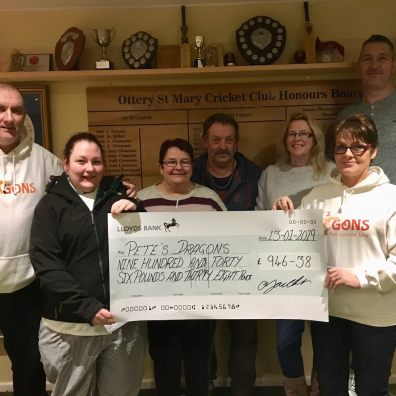 Gemma Youlden presents a cheque for £946 to Pete’s Dragons trustee and fellow Ottery St Mary resident Lesley Rowland. Also pictured (l-r) are Graham Rowland, Caroline and Dave Youlden, and Vicky and Rob Johns of Ottery Cricket Club.  