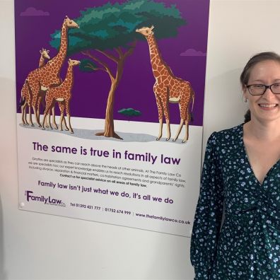 Two women next to poster