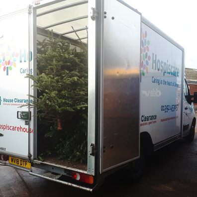 Hospiscare van being loaded with Christmas Trees 