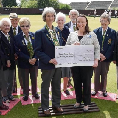 Nomads bowlers present a cheque for £1,500 to FORCE Cancer Charity