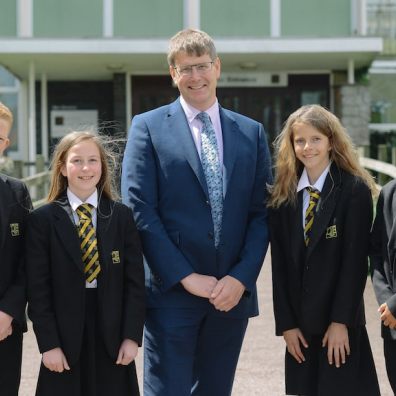 Headteacher Rupert Poole with students from Queen Elizabeth's School