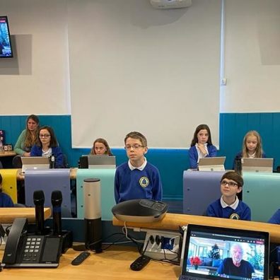 Jake (centre) talking to Sir Richard (onscreen) in the classroom